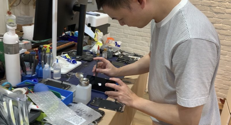 元通通訊行負責人修理手機的畫面 元通通訊行負責人修理手機的畫面